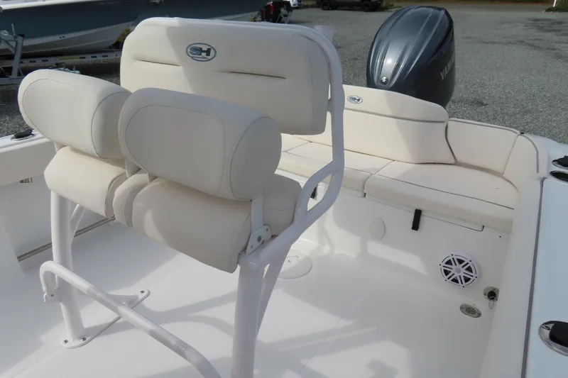 Slide: The Image of 2025 Sea Hunt Ultra 229 boat interior with cushioned seating and Yamaha engine. - 21