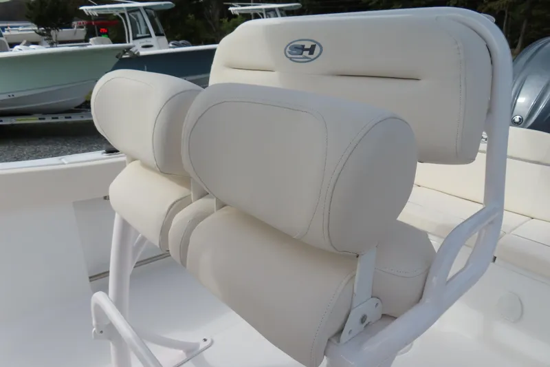 Slide: The Image of 2025 Sea Hunt Ultra 229 boat seat with white cushioned design. - 22