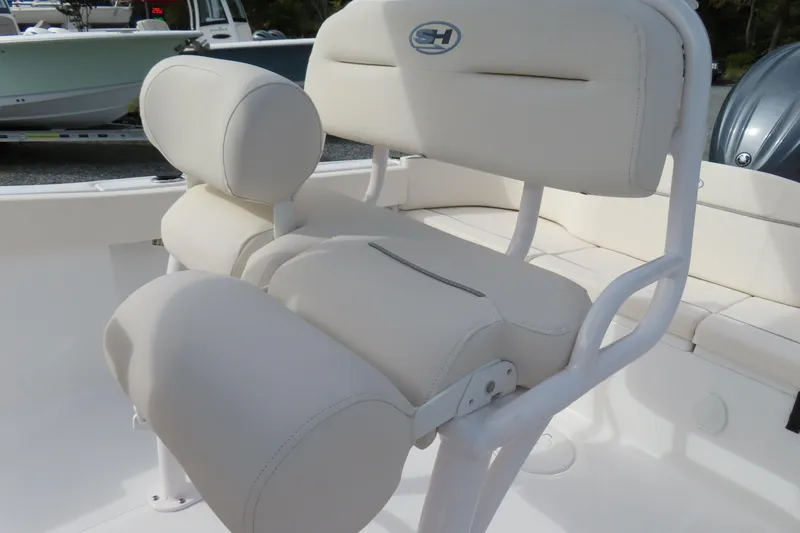 Slide: The Image of 2025 Sea Hunt Ultra 229 boat seat with white cushioned design. - 23