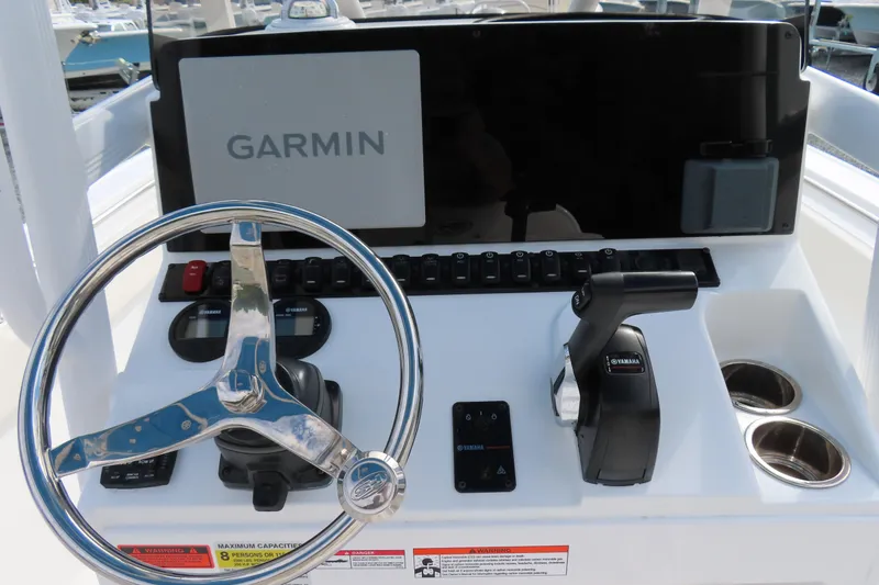 Slide: The Image of Control panel of 2025 Sea Hunt Ultra 229 boat with Garmin display and Yamaha throttle. - 24