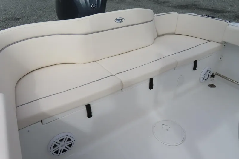 Slide: The Image of 2025 Sea Hunt Ultra 229 boat interior with cushioned seating and speaker system. - 28
