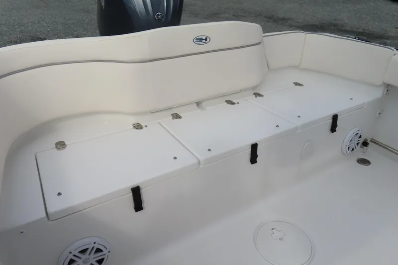 Slide: The Image of 2025 Sea Hunt Ultra 229 boat interior with white seating and storage compartments. - 29