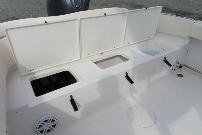 Slide: The Image of 2025 Sea Hunt Ultra 229 boat interior with storage compartments and speakers. - 30