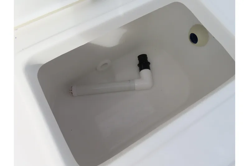 Slide: The Image of 2025 Sea Hunt Ultra 229 boat compartment with drainage pipe. - 32