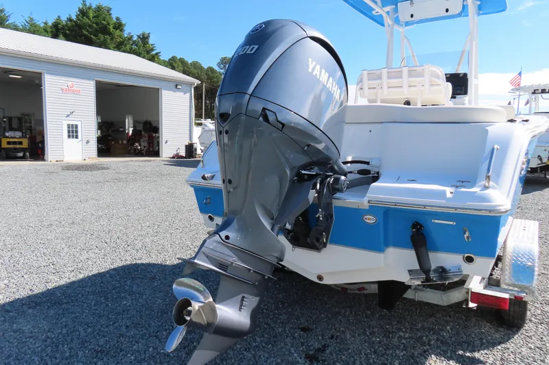 Slide: The Image of 2025 Sea Hunt Ultra 229 boat with Yamaha outboard motor in a marina setting. - 5