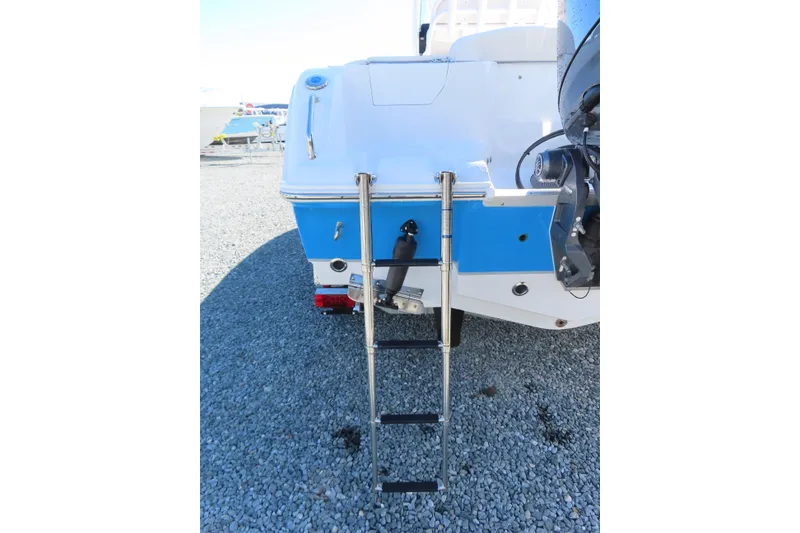 Slide: The Image of Rear view of 2025 Sea Hunt Ultra 229 boat with ladder on gravel. - 6