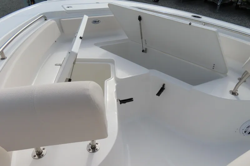 Slide: The Image of 2025 Sea Hunt Ultra 229 boat interior with open storage compartments and seating. - 9