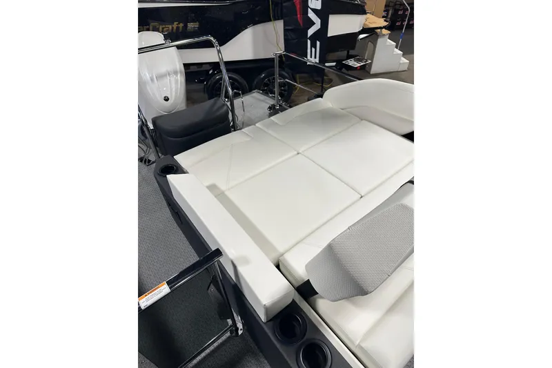 Slide: The Image of 2026 Evotti 723CS boat interior with white cushioned seating and cup holders. - 21