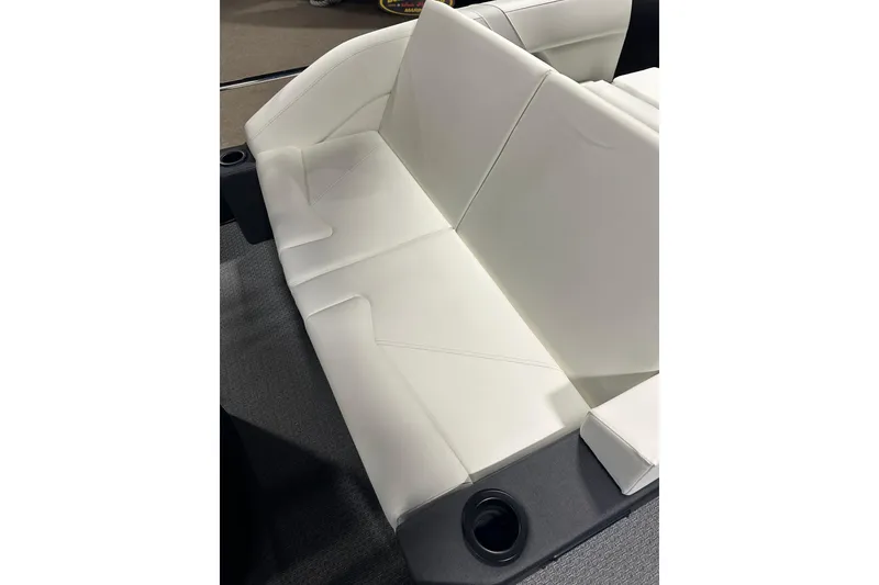 Slide: The Image of 2026 Evotti 723CS boat interior with white leather seating and cup holder. - 25