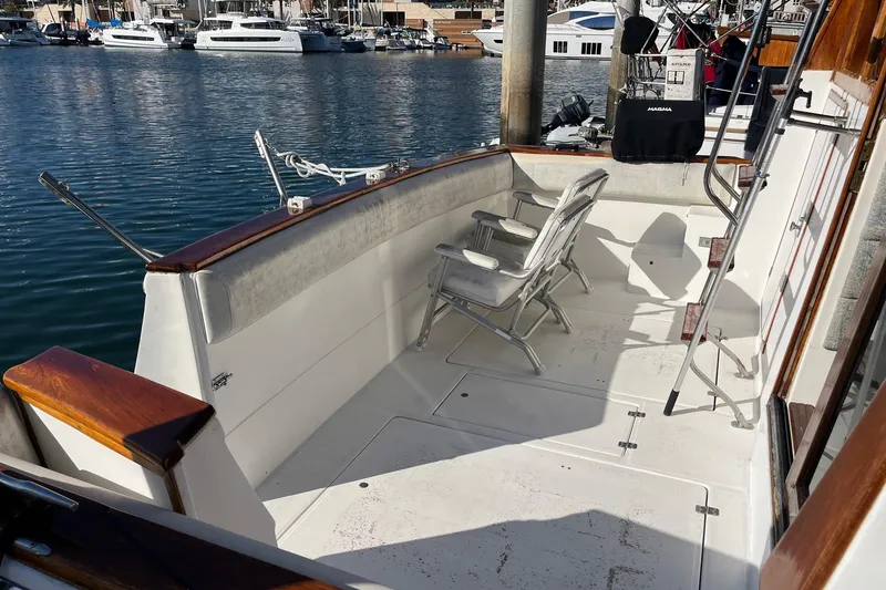 Slide: The Image of 1989 Bayliner 3888 MY Sedan boat deck with chairs, docked in marina. - 18