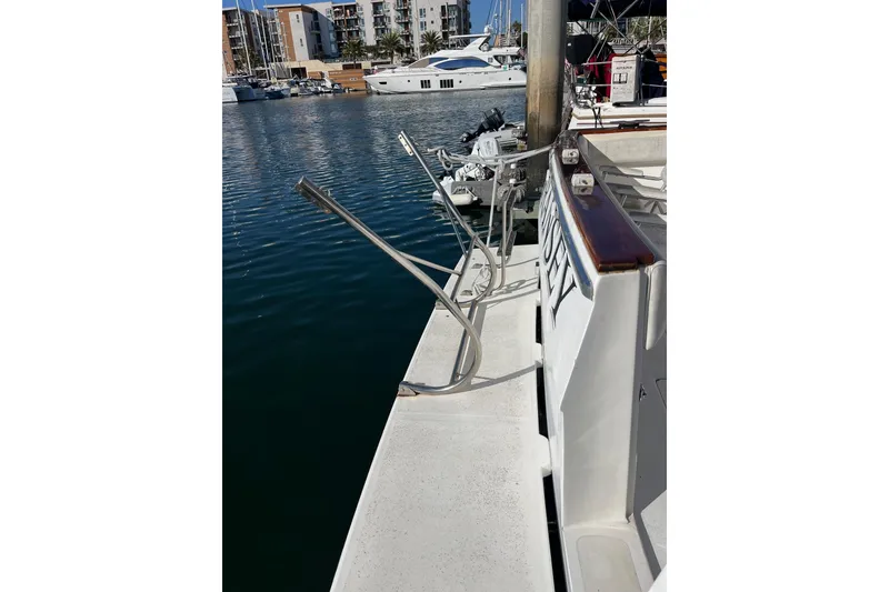 Slide: The Image of 1989 Bayliner 3888 MY Sedan docked at marina, surrounded by other boats. - 19