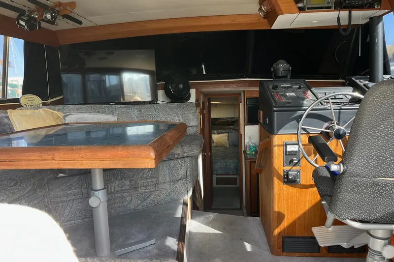 Slide: The Image of 1989 Bayliner 3888 MY Sedan interior with helm, seating, and table. - 3