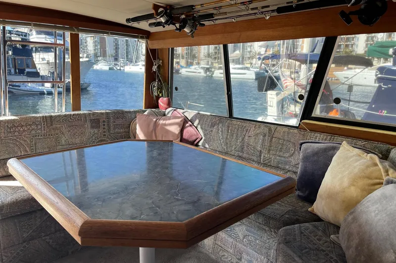 Slide: The Image of Interior of 1989 Bayliner 3888 MY Sedan with marina view through large windows. - 4