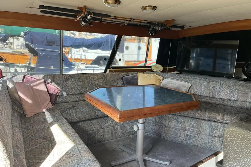 Slide: The Image of Interior of 1989 Bayliner 3888 MY Sedan with cozy seating and a table. - 5