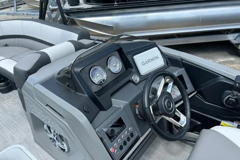 Slide: The Image of 2024 Avalon Catalina Platinum Rear Lounger dashboard with Garmin navigation system. - 2