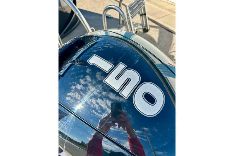 Slide: The Image of Reflection on Barletta ARIA 22QC 2024 boat surface with sky and person. - 12
