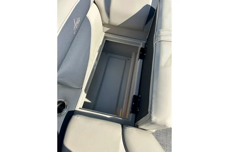 Slide: The Image of 2024 Barletta ARIA 22QC boat seat storage compartment, open with visible interior. - 14