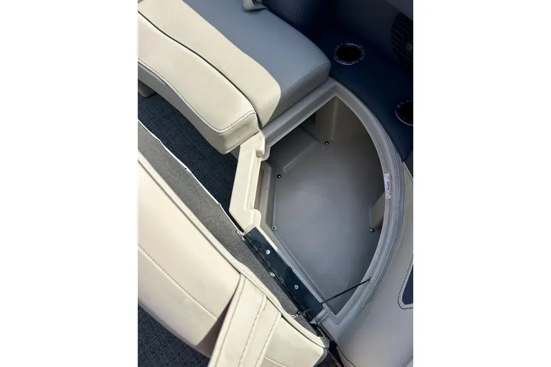 Slide: The Image of 2024 Barletta ARIA 22QC boat interior storage compartment with beige seating. - 16