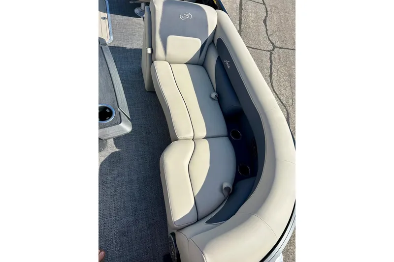 Slide: The Image of 2024 Barletta ARIA 22QC boat interior with plush seating and cup holders. - 18