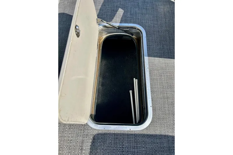 Slide: The Image of Open storage compartment on 2024 Barletta ARIA 22QC boat, featuring a sleek design. - 25