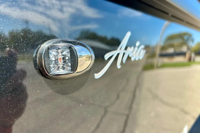 Slide: The Image of 2024 Barletta ARIA 22QC logo and light detail on sleek exterior. - 3