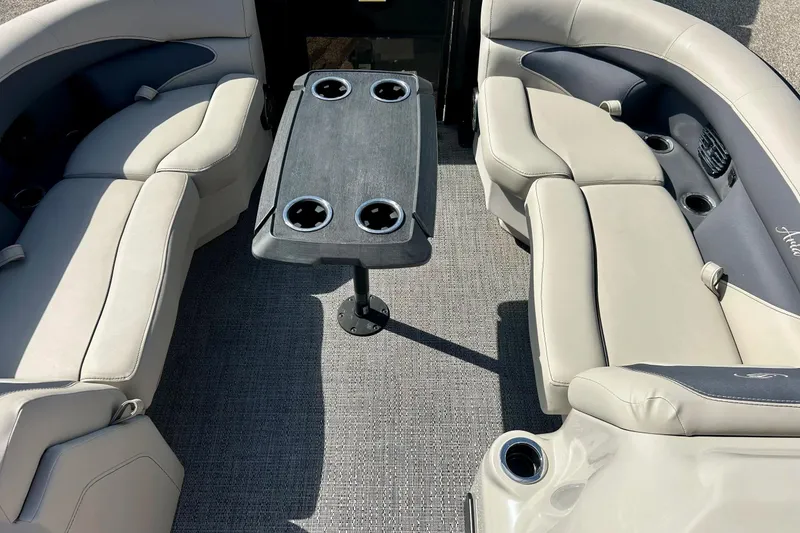 Slide: The Image of 2024 Barletta ARIA 22QC boat interior with plush seating and central table. - 31