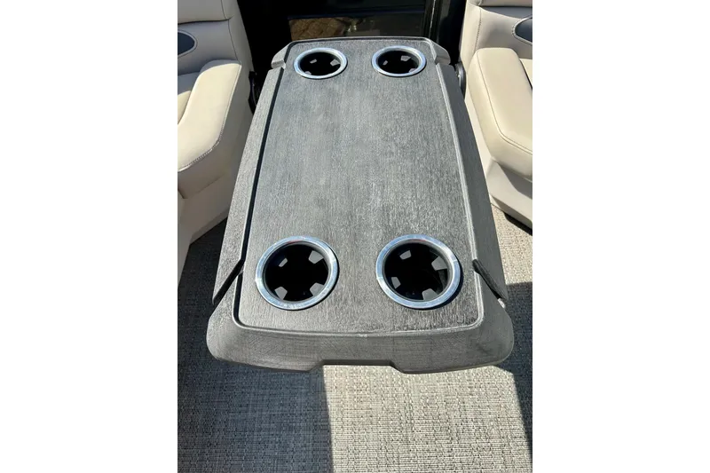 Slide: The Image of 2024 Barletta ARIA 22QC boat table with four cup holders, beige seating. - 32