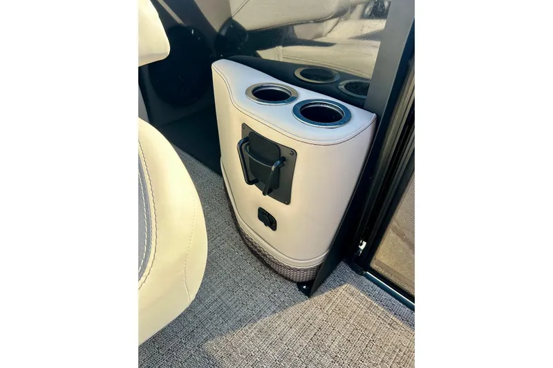 Slide: The Image of 2024 Barletta ARIA 22QC interior with cup holders and beige upholstery. - 33