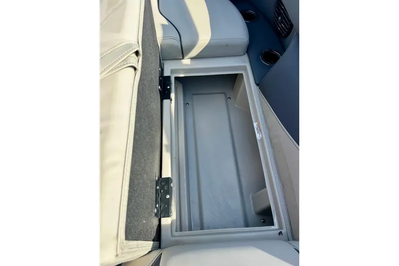Slide: The Image of 2024 Barletta ARIA 22QC boat storage compartment with open seat and cup holders. - 39