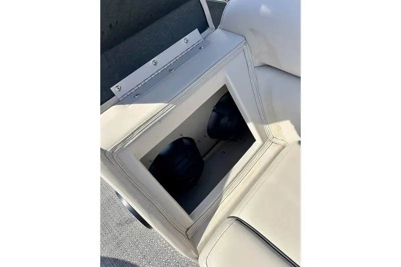Slide: The Image of 2024 Barletta ARIA 22QC boat seat storage compartment with speakers visible inside. - 43