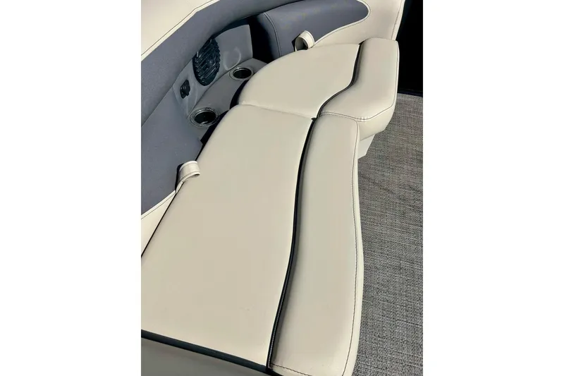 Slide: The Image of 2024 Barletta ARIA 22QC boat interior with beige seating and cup holders. - 44