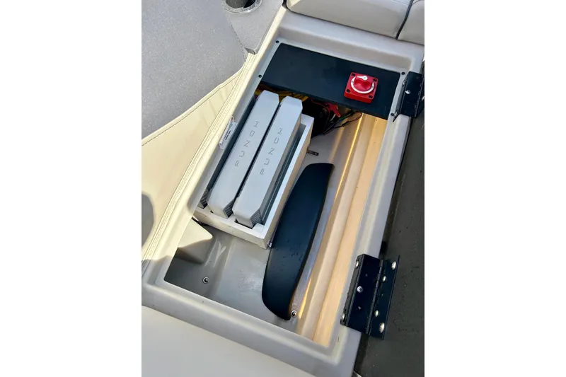 Slide: The Image of 2024 Barletta ARIA 22QC storage compartment with Punch audio equipment and red power switch. - 45