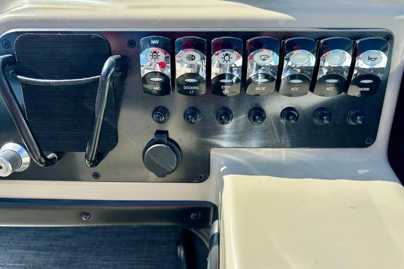 Slide: The Image of Control panel of 2024 Barletta ARIA 22QC boat with labeled switches and outlets. - 59