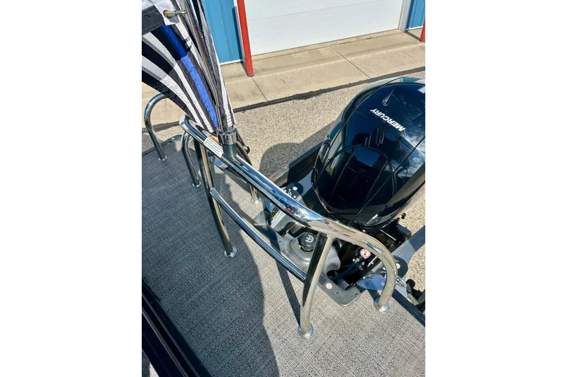 Slide: The Image of 2024 Barletta ARIA 22QC boat with Mercury outboard motor and chrome railing. - 64