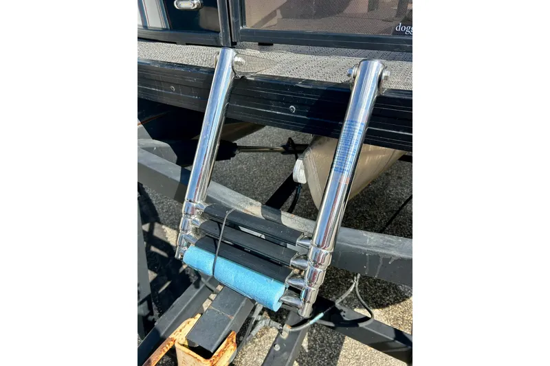Slide: The Image of Chrome boat ladder on 2024 Barletta ARIA 22QC, resting on a trailer. - 9