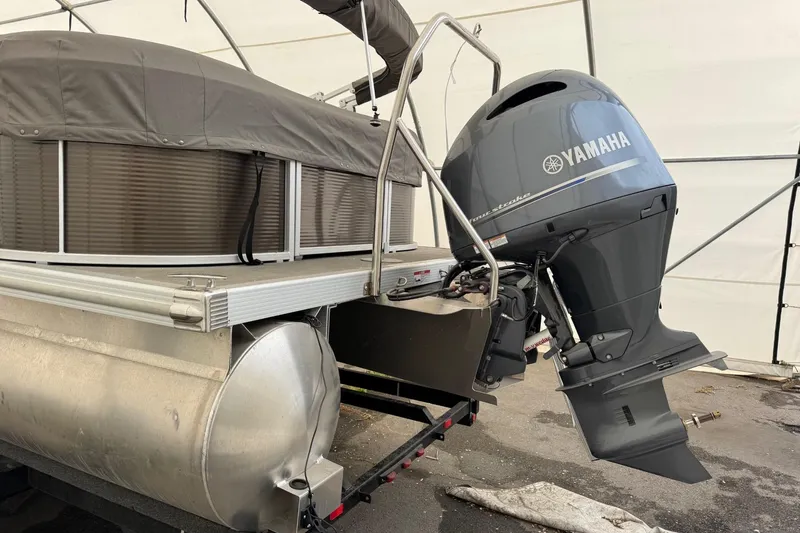 Slide: The Image of 2023 Bennington 23SSR pontoon boat with Yamaha outboard motor in storage. - 4