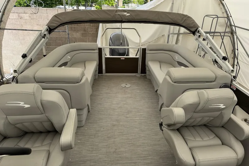Slide: The Image of 2023 Bennington 23SSR pontoon boat interior with beige seating and canopy. - 7