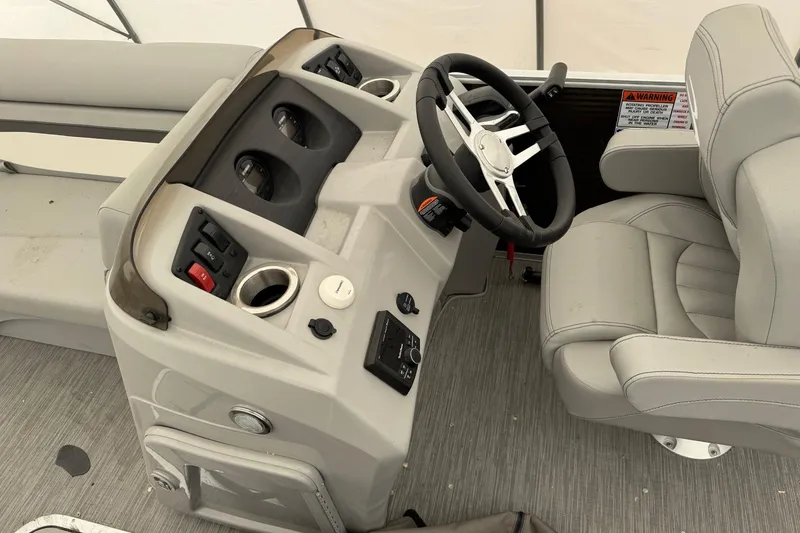 Slide: The Image of 2023 Bennington 23SSR boat interior with steering wheel and control panel. - 8