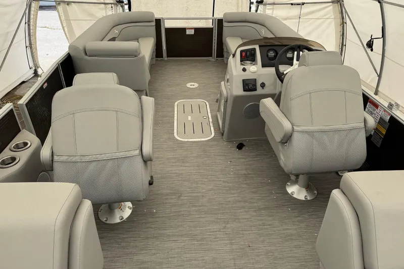 Slide: The Image of Interior of a 2023 Bennington 23SSR pontoon boat with gray seating and steering console. - 9