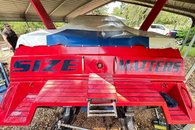 Slide: The Image of 1987 Chris-Craft 312 Stinger boat with "Size Matters" text on red stern. - 21