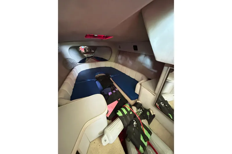 Slide: The Image of 1987 Chris-Craft 312 Stinger cabin interior with seating and storage. - 33