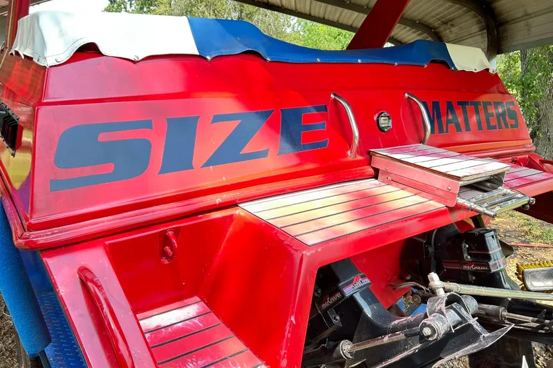 Slide: The Image of 1987 Chris-Craft 312 Stinger boat with bold "Size Matters" text on red exterior. - 6