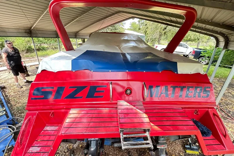 Slide: The Image of 1987 Chris-Craft 312 Stinger boat under cover, red with "Size Matters" text. - 7