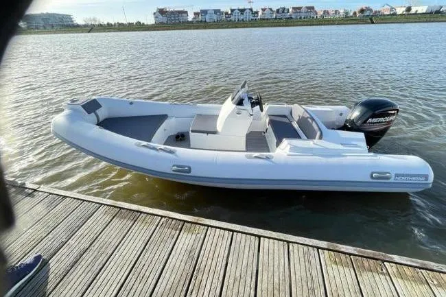 Slide: The Image of 2026 Northstar Axis 5.3 boat with Yamaha 115HP engine docked on calm water. - 9