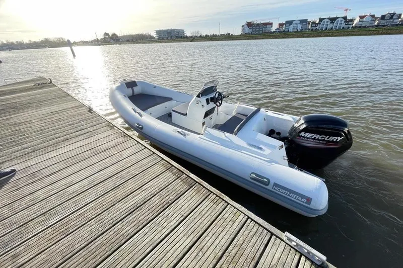 Slide: The Image of 2026 Northstar Axis 5.3 boat with Yamaha 115HP engine docked by the water. - 10