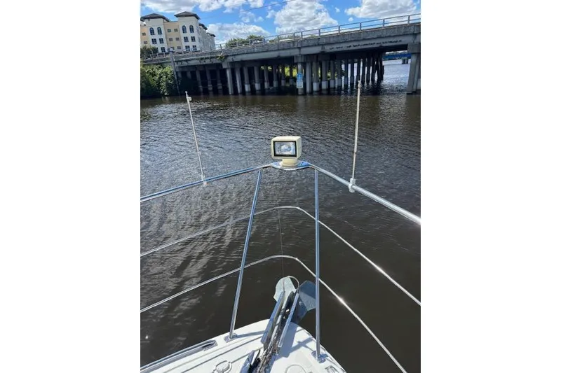 Slide: The Image of 2004 Carver 466 Motor Yacht deck with railing and fenders on a sunny day. - 30