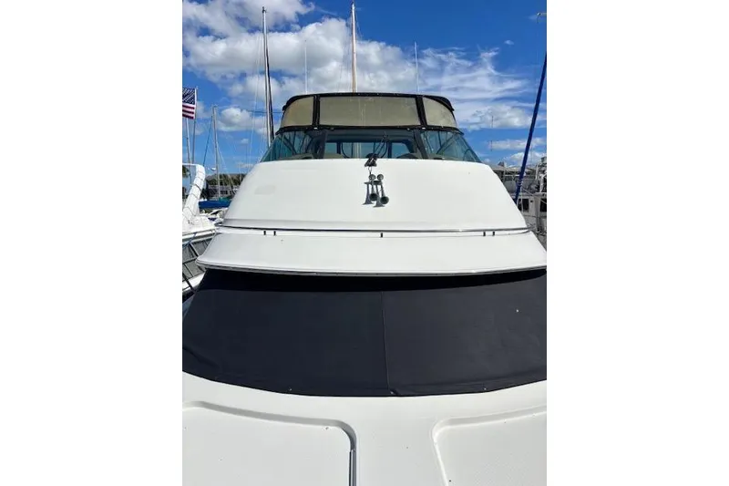 Slide: The Image of 2004 Carver 466 Motor Yacht with sleek white exterior and tinted windows. - 34