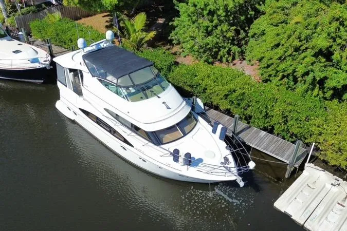 Slide: The Image of 2004 Carver 466 Motor Yacht docked by lush greenery. - 4