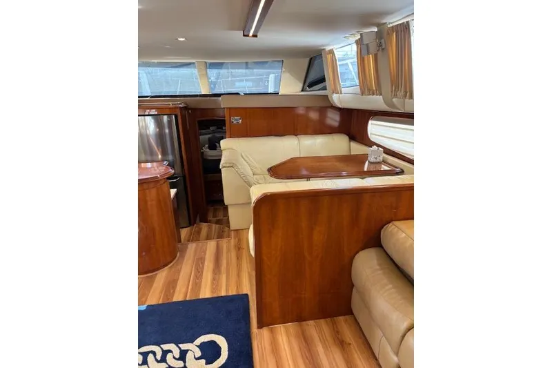 Slide: The Image of Luxurious interior of 2004 Carver 466 Motor Yacht with leather seating and wood accents. - 41