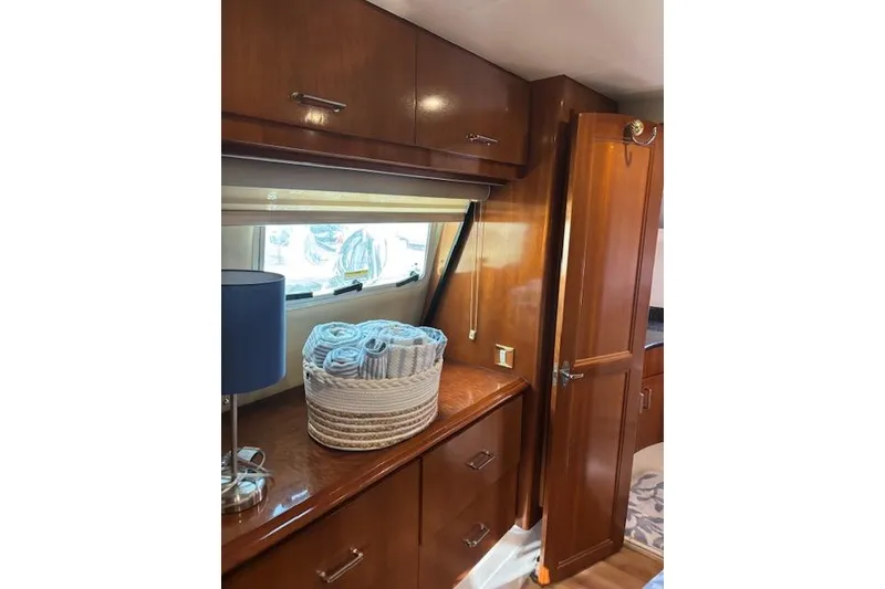 Slide: The Image of Interior of 2004 Carver 466 Motor Yacht with wooden cabinetry and bathroom view. - 49